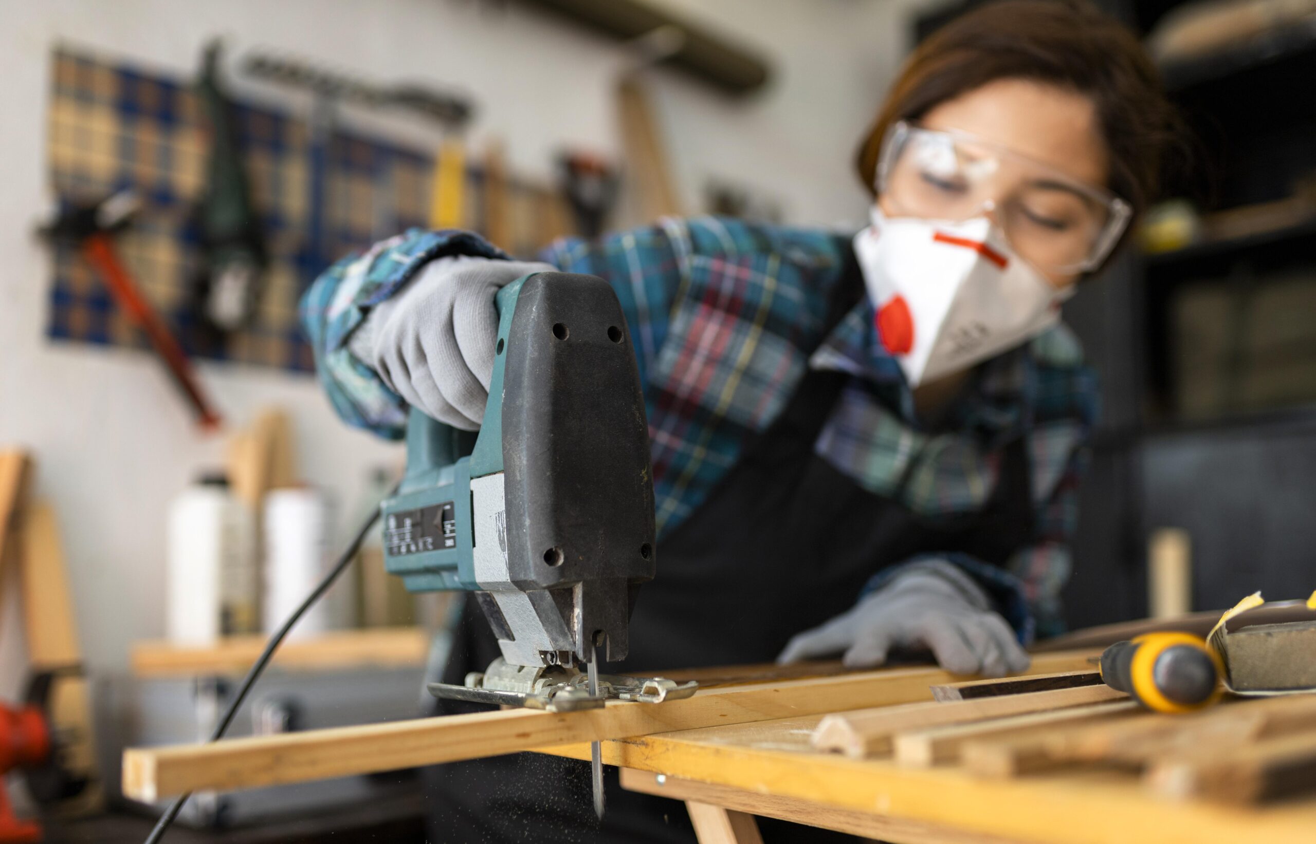 female-working-workshop-with-hammer-drill